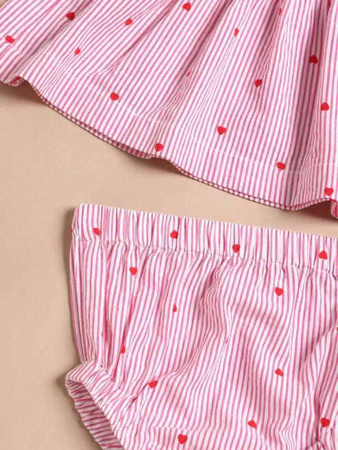 Red and white striped children's outfit with heart patterns