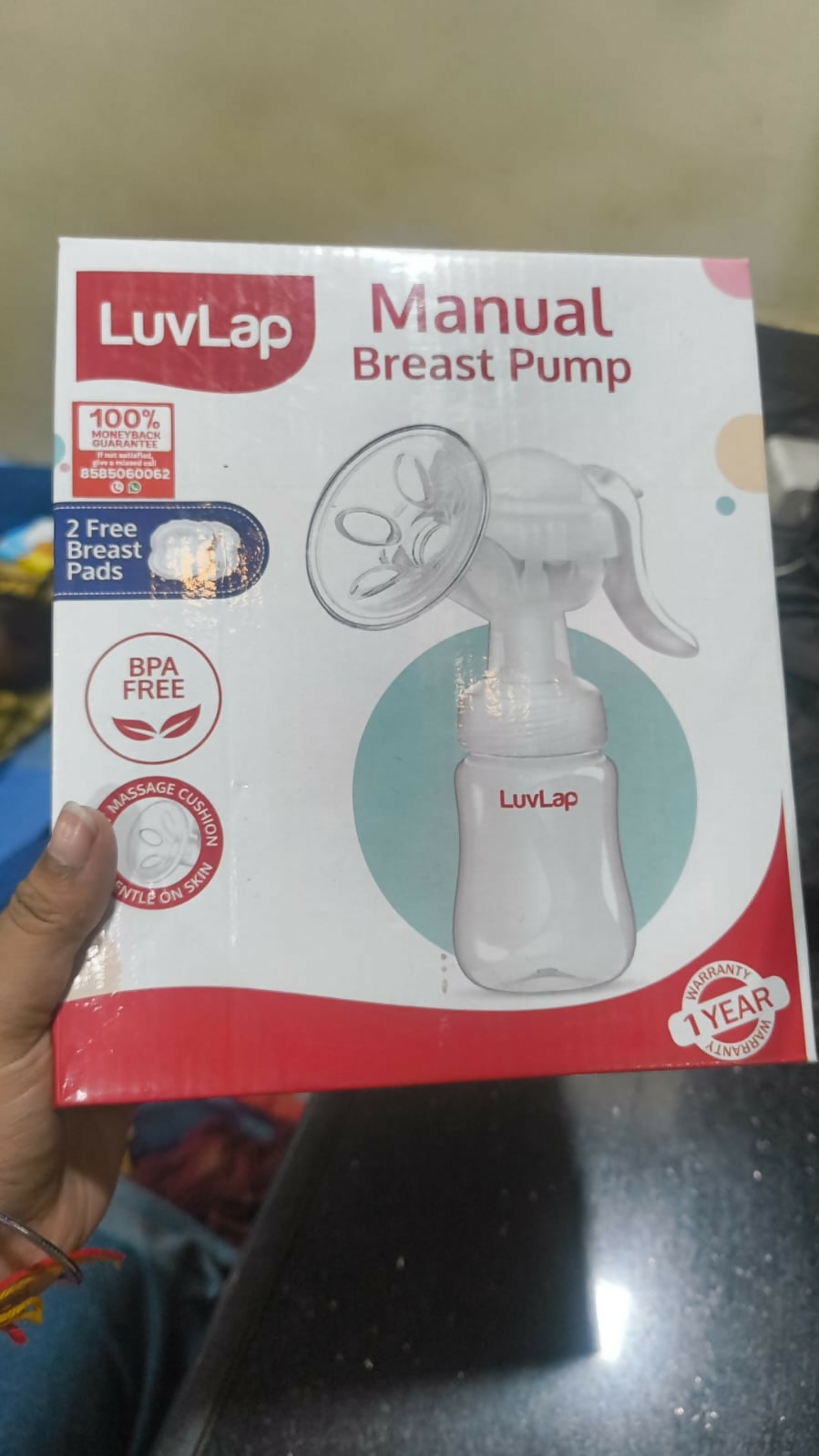 LuvLap manual breast pump packaging on a dark surface