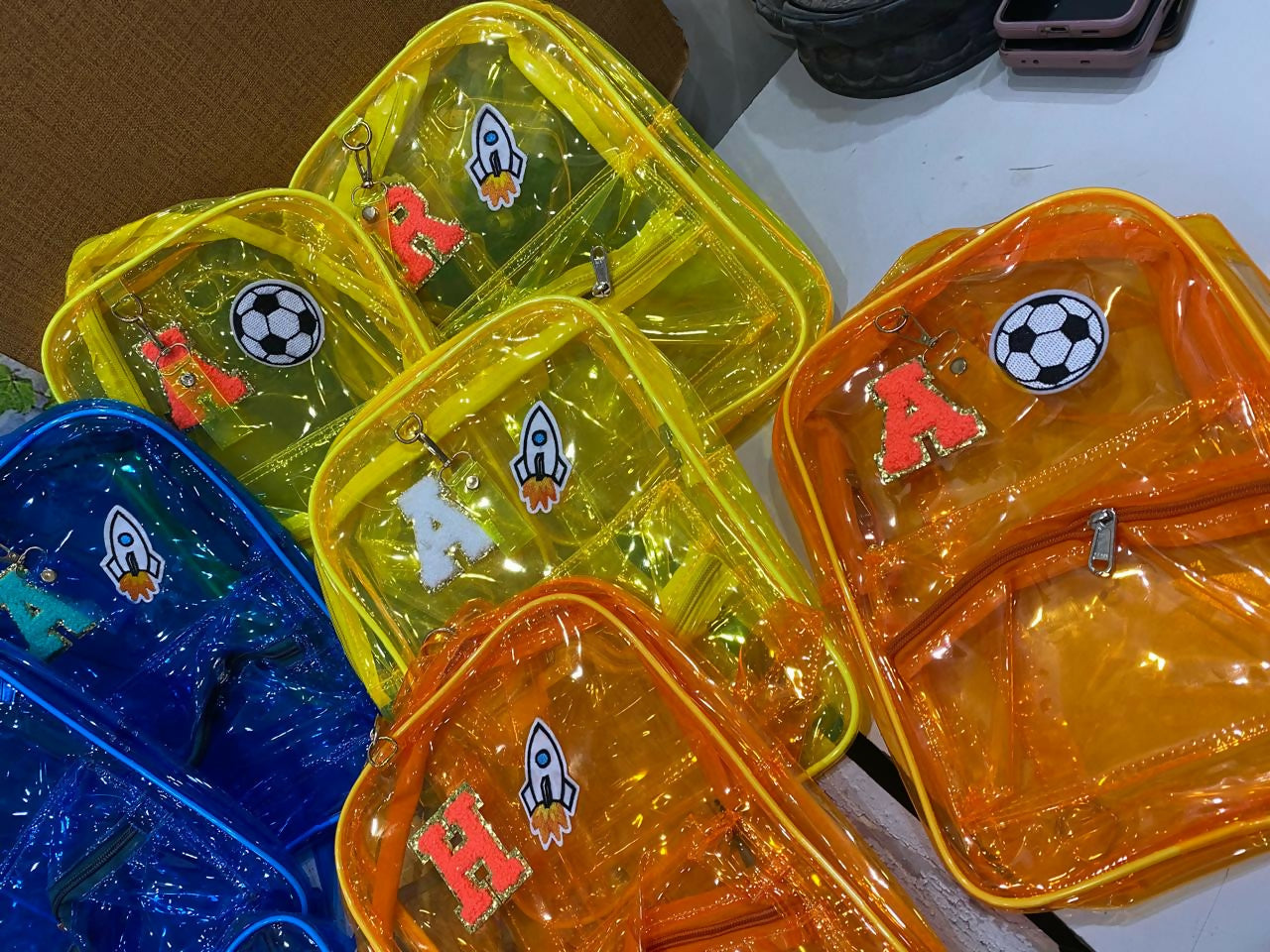 Colorful transparent bags with various designs on a white surface