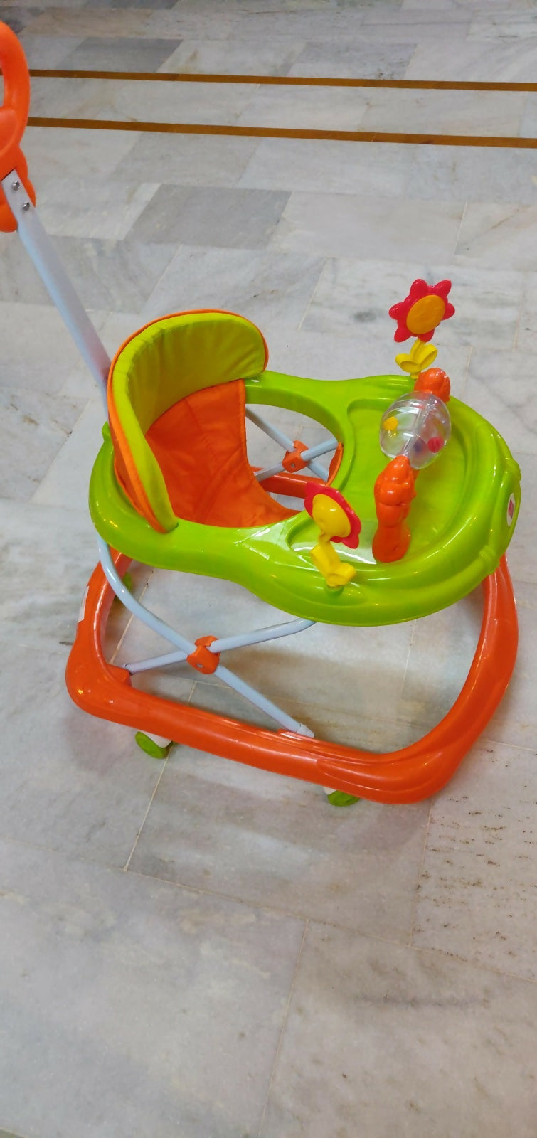 Colorful baby walker on a tiled floor