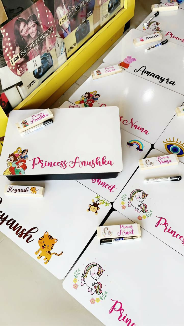 Collection of personalized name cards with cartoon designs on a white surface.