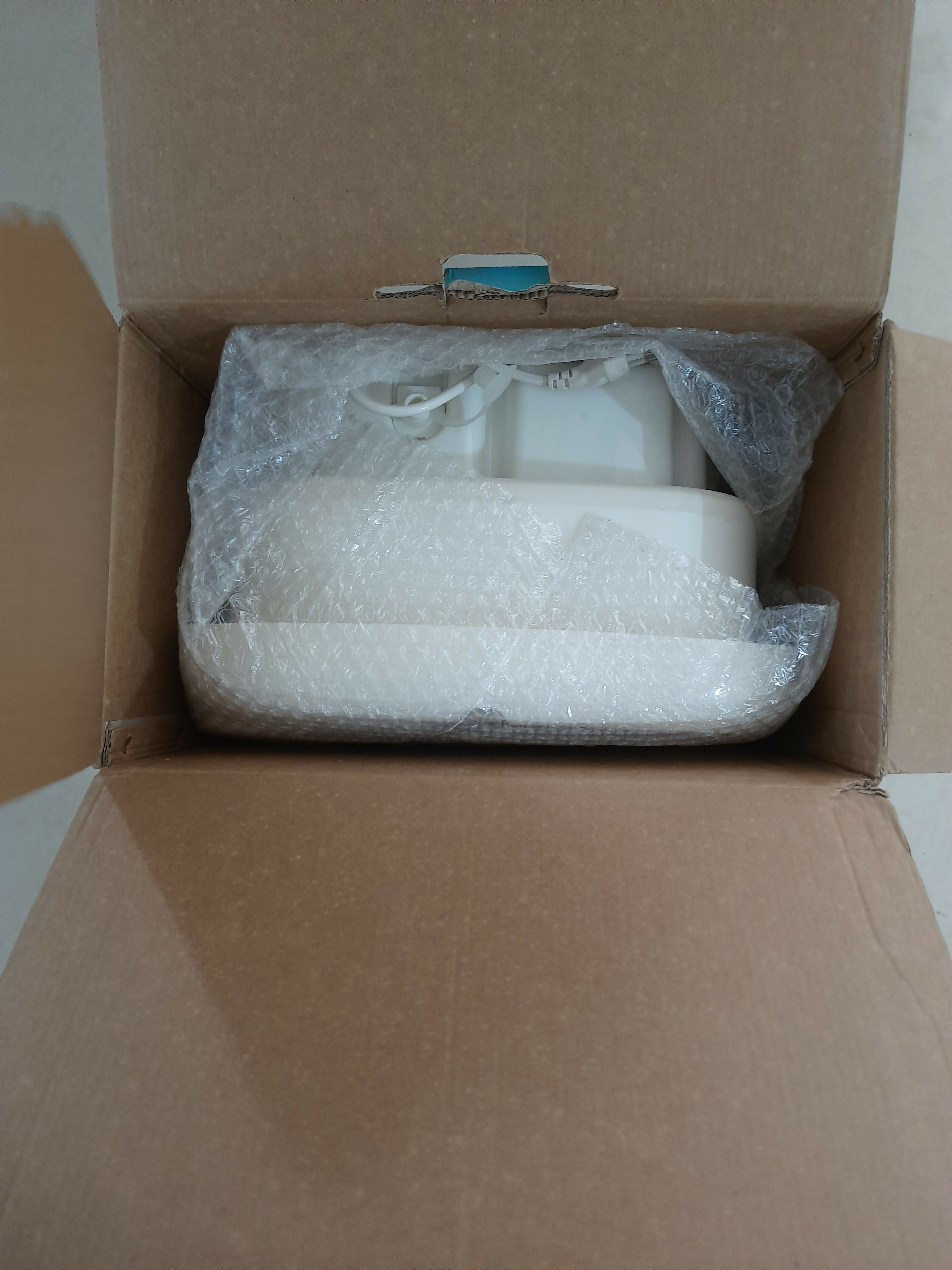 Product wrapped in bubble wrap inside an open cardboard box.