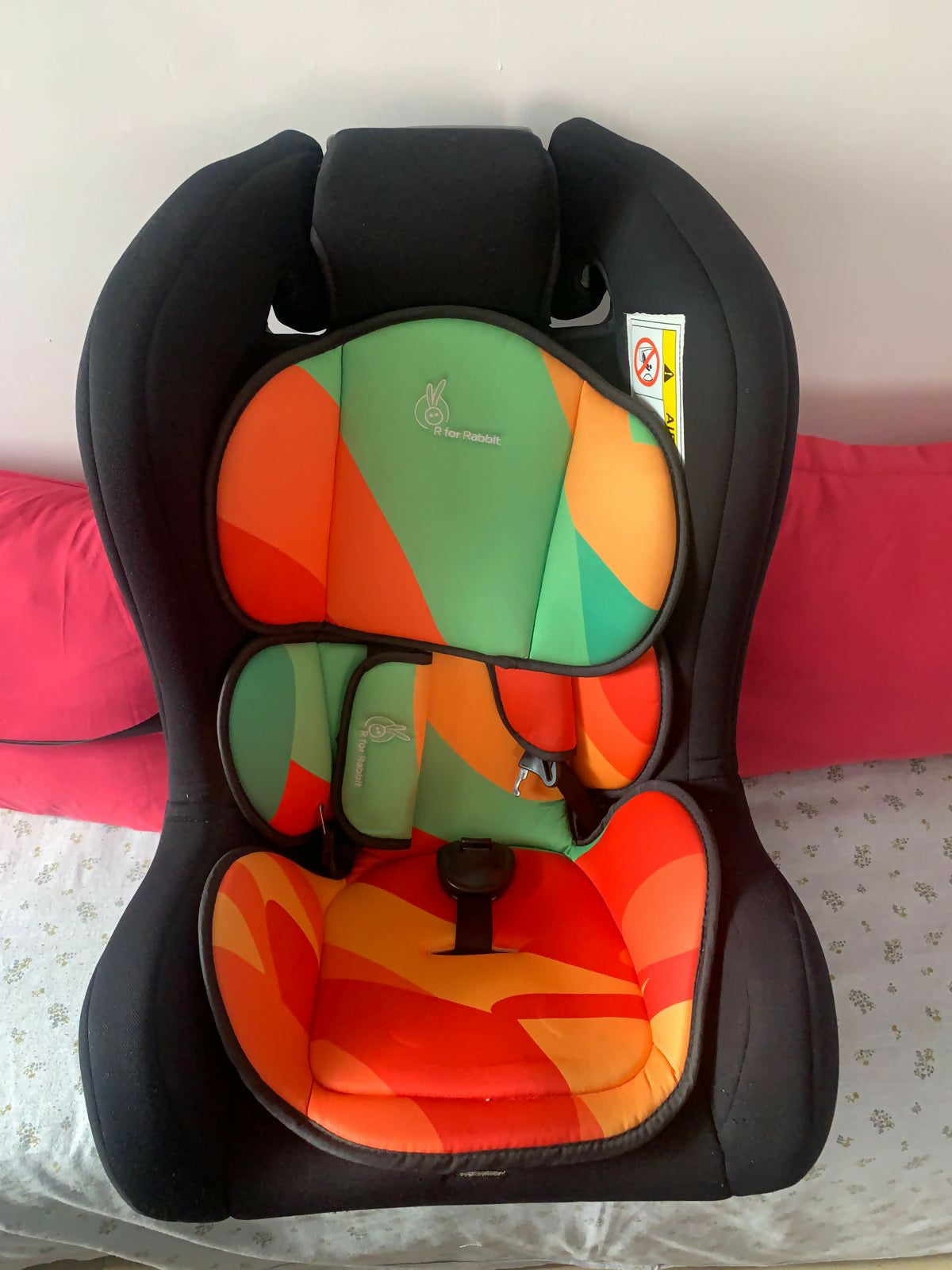 Colorful child car seat with a black frame