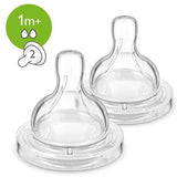 Two clear baby bottle nipples with a green label indicating '1m+' on a white background.