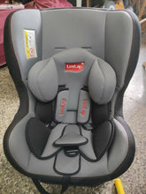 Gray and black car seat with LuvLap branding on a concrete floor.