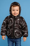 Child wearing a black puffer jacket with bear patterns