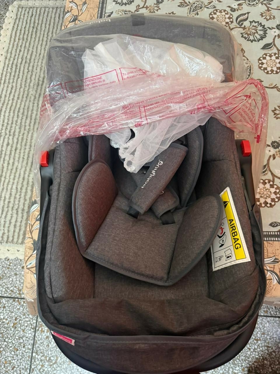 BABYHUG 4 in 1 car seat cum carry cot with multi-function design, safety harness, cushioned seating, portable carry handle, and comfortable travel support for babies.