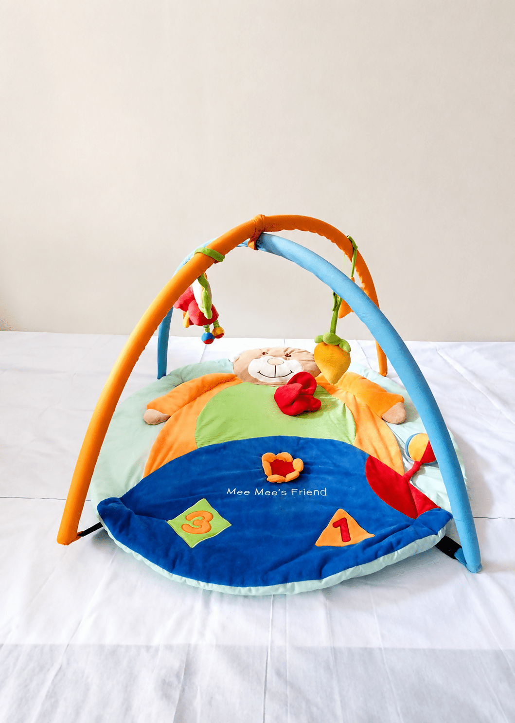 Mee Mee Baby Activity Play Gym Tummy Time Mat with hanging toys, soft cushioned mat, foldable design, and carry bag to encourage tummy time, sensory development, and motor skills.