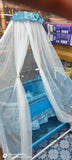 Baby jhula in blue with mosquito net and storage basket, featuring a gentle rocking design, cozy sleeping space, protective net, and convenient storage for baby essentials.