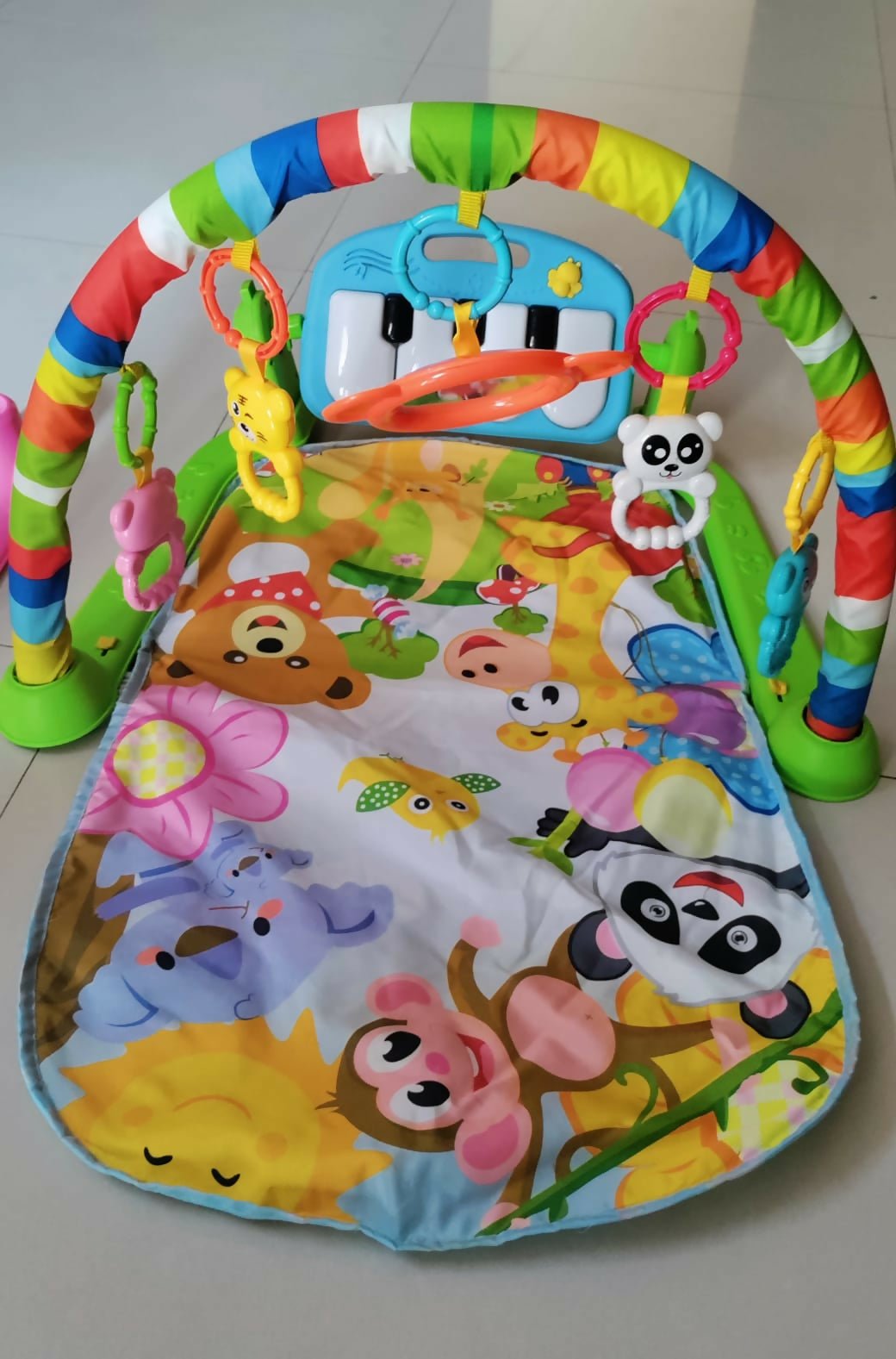 Baby musical play gym and piano mat with a soft padded play mat, hanging toys, piano keyboard, and interactive lights and sounds to encourage tummy time, sensory exploration, and early development.