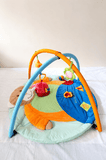 Mee Mee Baby Activity Play Gym Tummy Time Mat with hanging toys, soft cushioned mat, foldable design, and carry bag to encourage tummy time, sensory development, and motor skills.