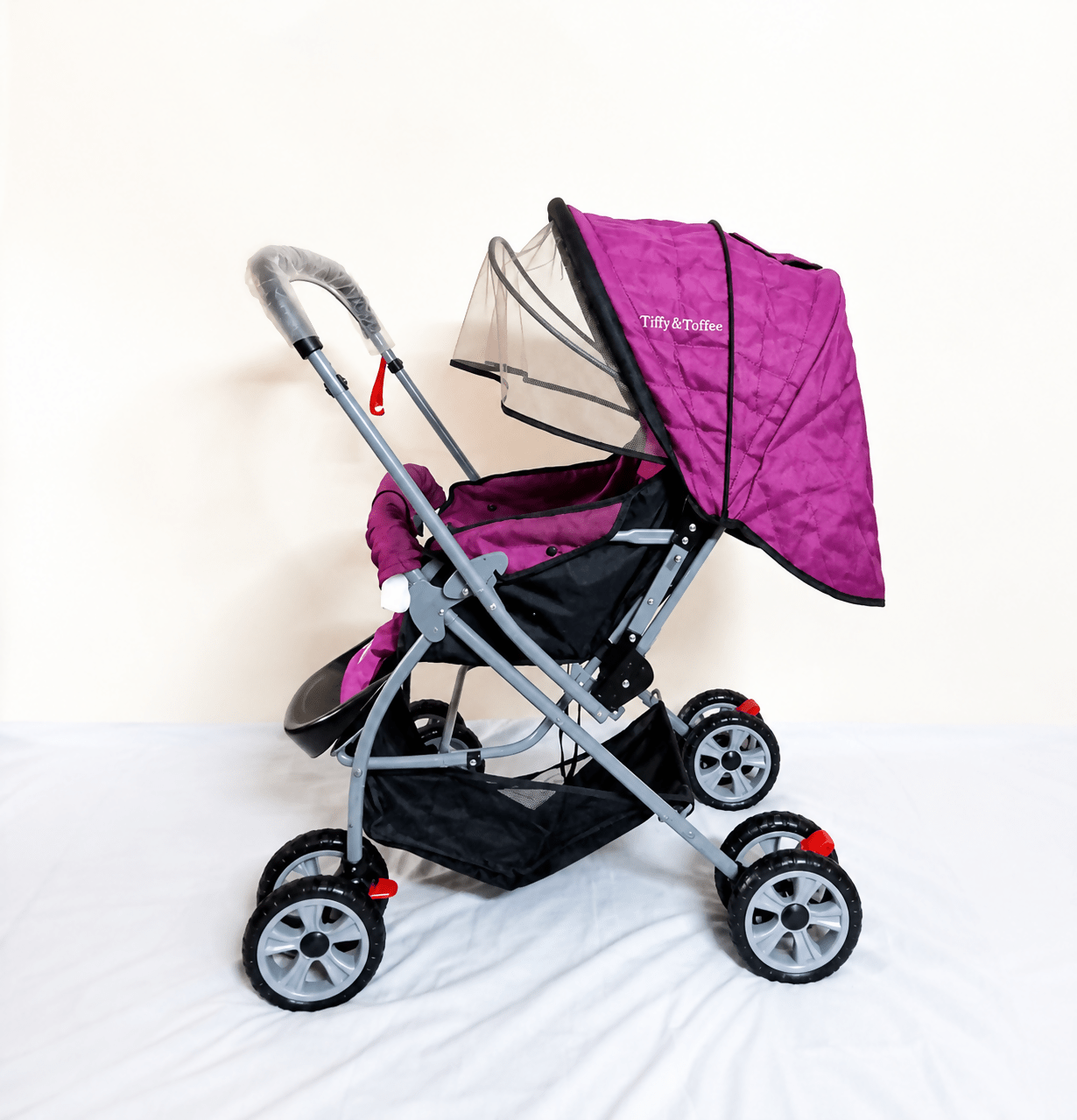 Tiffy & Toffee Maxtrem baby stroller with reversible handle, reclining seat, foldable travel pram design, adjustable canopy, 5-point safety harness, smooth wheels, and storage basket for babies and toddlers up to 22 kg.