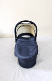 babycab Noah Carrycot Bassinet in Navy Blue, designed as a stroller attachment with a comfortable padded interior, protective canopy, sturdy construction, and cozy lie-flat space for newborns and young infants.