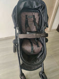 Evenflo travel system with baby stroller and infant car seat, featuring a foldable design, reclining seat, adjustable canopy, 5-point safety harness, and spacious storage basket for convenient travel.