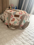 Diaper bag with multiple storage compartments, insulated bottle pockets, comfortable shoulder straps, and a spacious design for organizing baby essentials during travel and everyday outings.