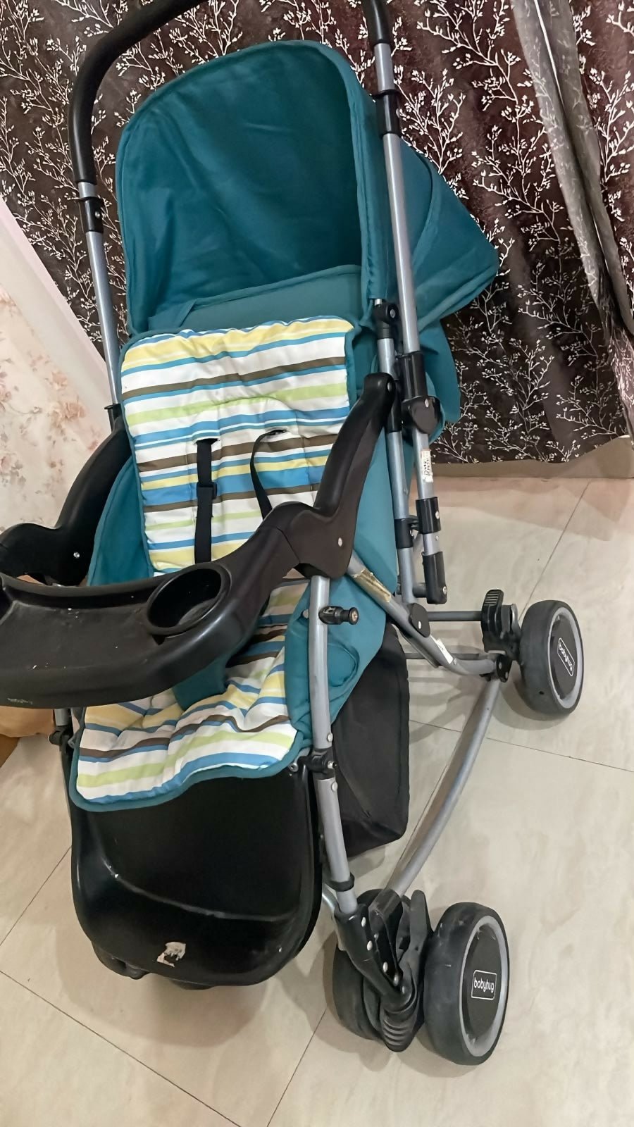 BABYHUG Stroller/Pram with a comfortable reclining seat, foldable frame, adjustable canopy, safety harness, smooth wheels, and storage basket for convenient everyday outings with babies and toddlers.