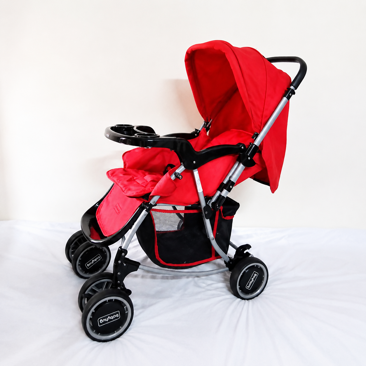 Babyhug 2-in-1 Rock and Roll stroller with rocker mode, reversible handle, reclining seat, 5-point safety harness, adjustable canopy, and smooth wheels for comfortable rides.