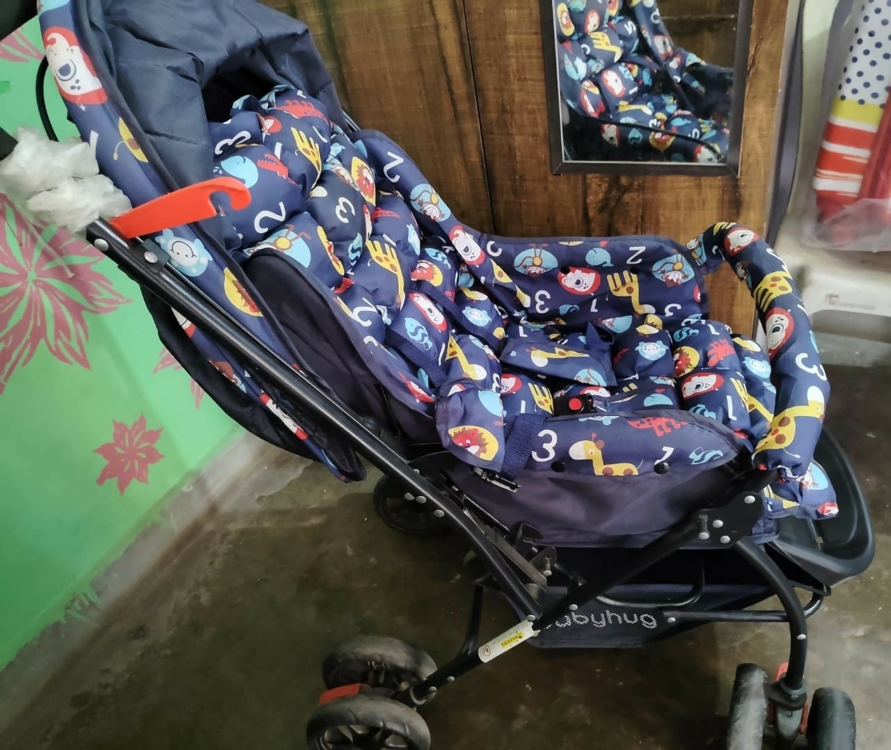 BABYHUG Cosy Cosmo Stroller/Pram in Navy Blue with reversible handle, comfortable reclining seat, adjustable canopy, back pocket, safety harness, smooth wheels, and foldable design for convenient baby travel.