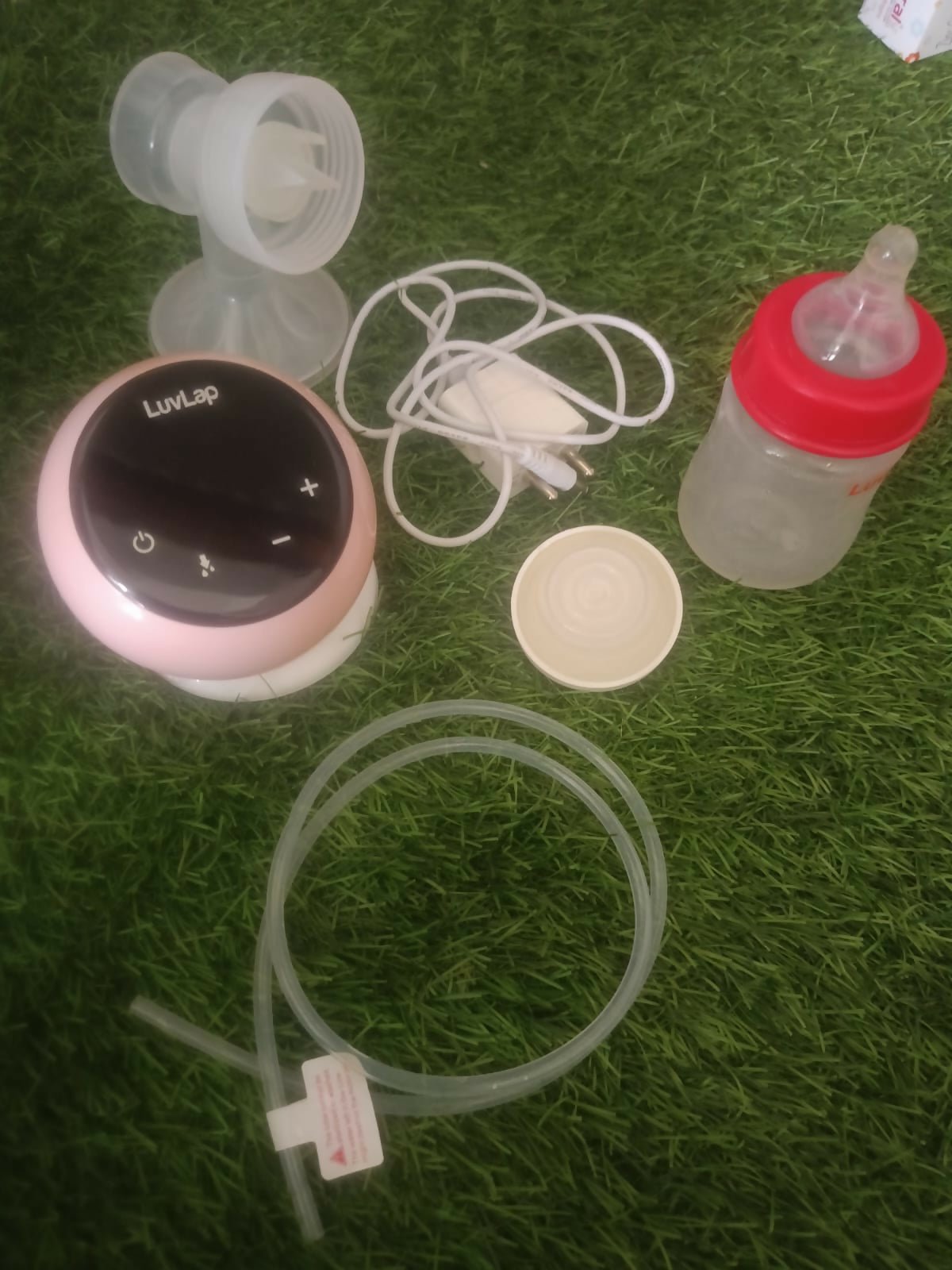 LUVLAP Adore electric breast pump with LUVLAP feeding bottle, adjustable suction settings, compact design, and convenient milk collection support for breastfeeding mothers.