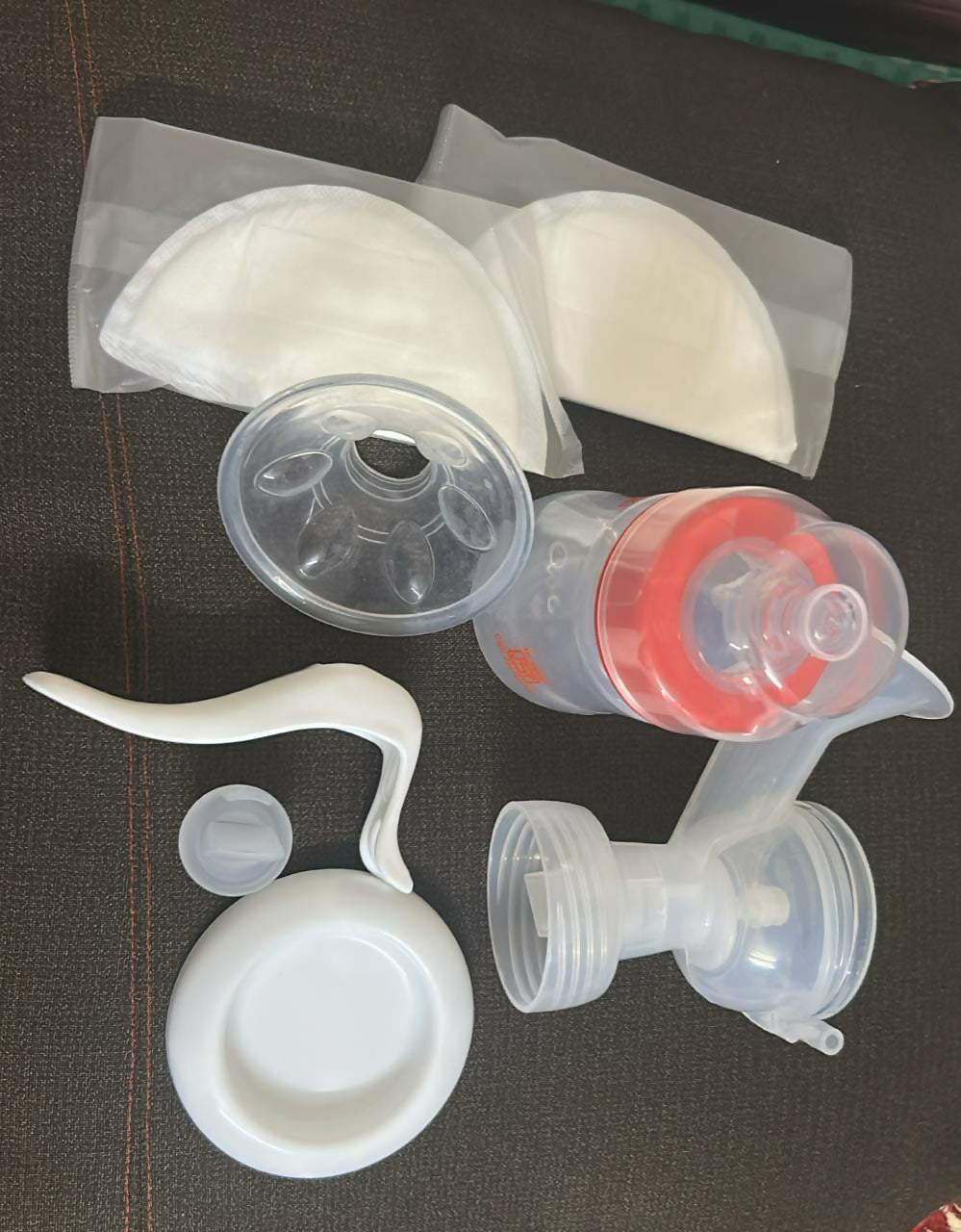 Collection of silicone breast pump parts on a dark surface
