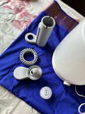 White diffuser and its parts on a blue cloth with floral fabric background