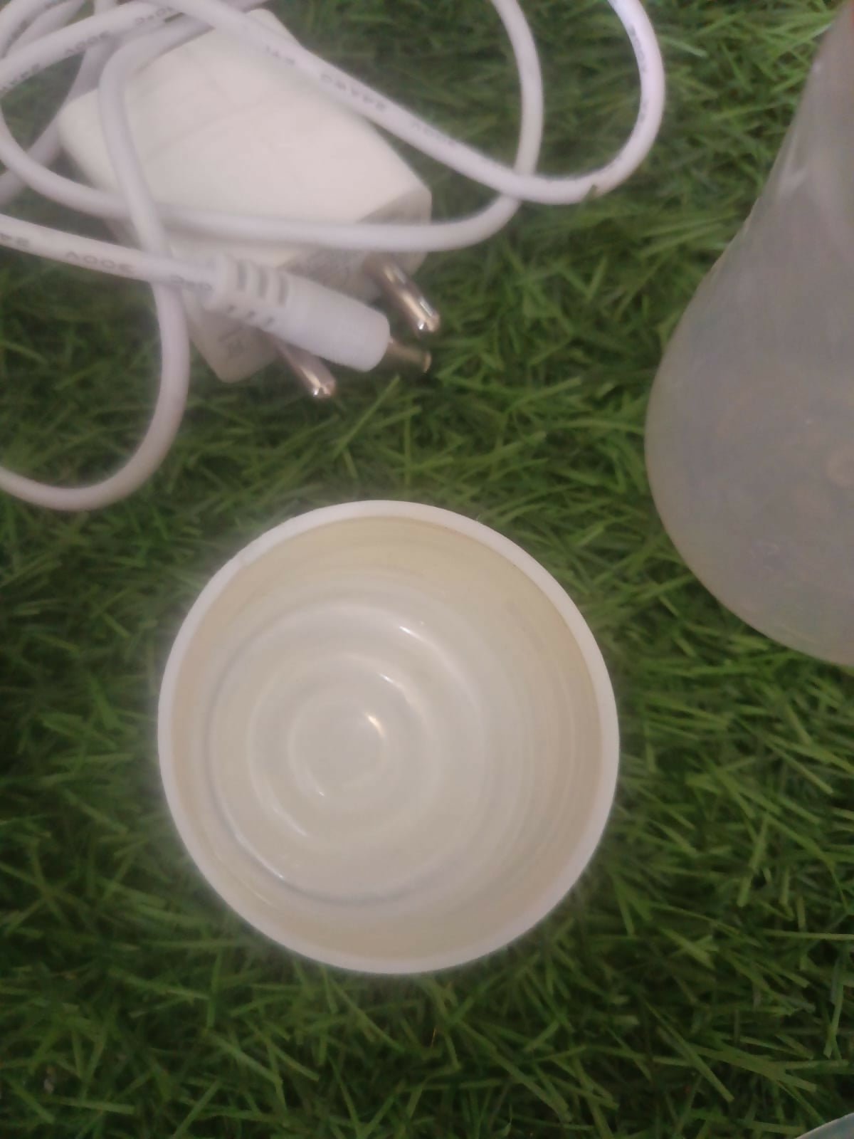 LUVLAP Adore electric breast pump with LUVLAP feeding bottle, adjustable suction settings, compact design, and convenient milk collection support for breastfeeding mothers.