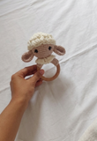 Handmade crochet rattle for babies with soft yarn construction, easy-to-hold design, gentle rattling sound, and baby-friendly craftsmanship for sensory play and development.