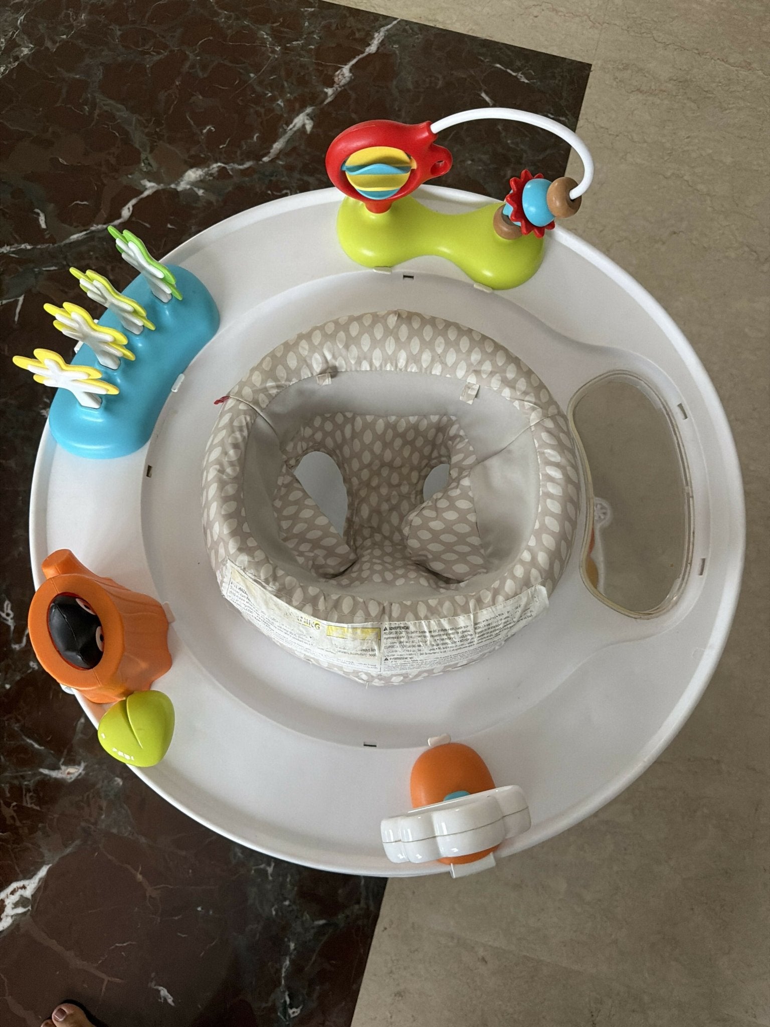 Skip Hop Play Gym with a soft padded play mat, hanging developmental toys, baby-safe mirror, and interactive activities to encourage tummy time, sensory exploration, and early development.