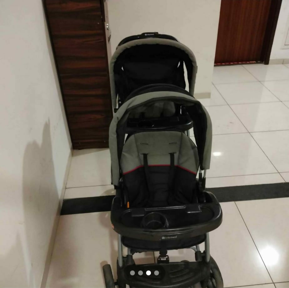 Sit & Stand Twin Baby Stroller with dual seating arrangement, sit-and-stand configuration, comfortable seats, safety harnesses, protective canopy, smooth wheels, and convenient storage for travelling with two children.