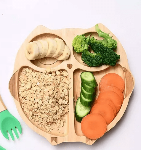 Bamboo plate with a strong silicone suction base, divided sections, smooth rounded edges, and eco-friendly food-grade construction for mess-free baby and toddler mealtimes.