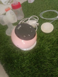 LUVLAP Adore electric breast pump with LUVLAP feeding bottle, adjustable suction settings, compact design, and convenient milk collection support for breastfeeding mothers.