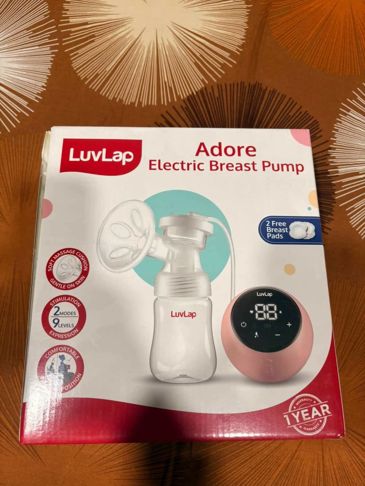 LUVLAP Adore electric breast pump with adjustable suction settings, compact design, milk collection bottle, and comfortable pumping support for breastfeeding mothers.