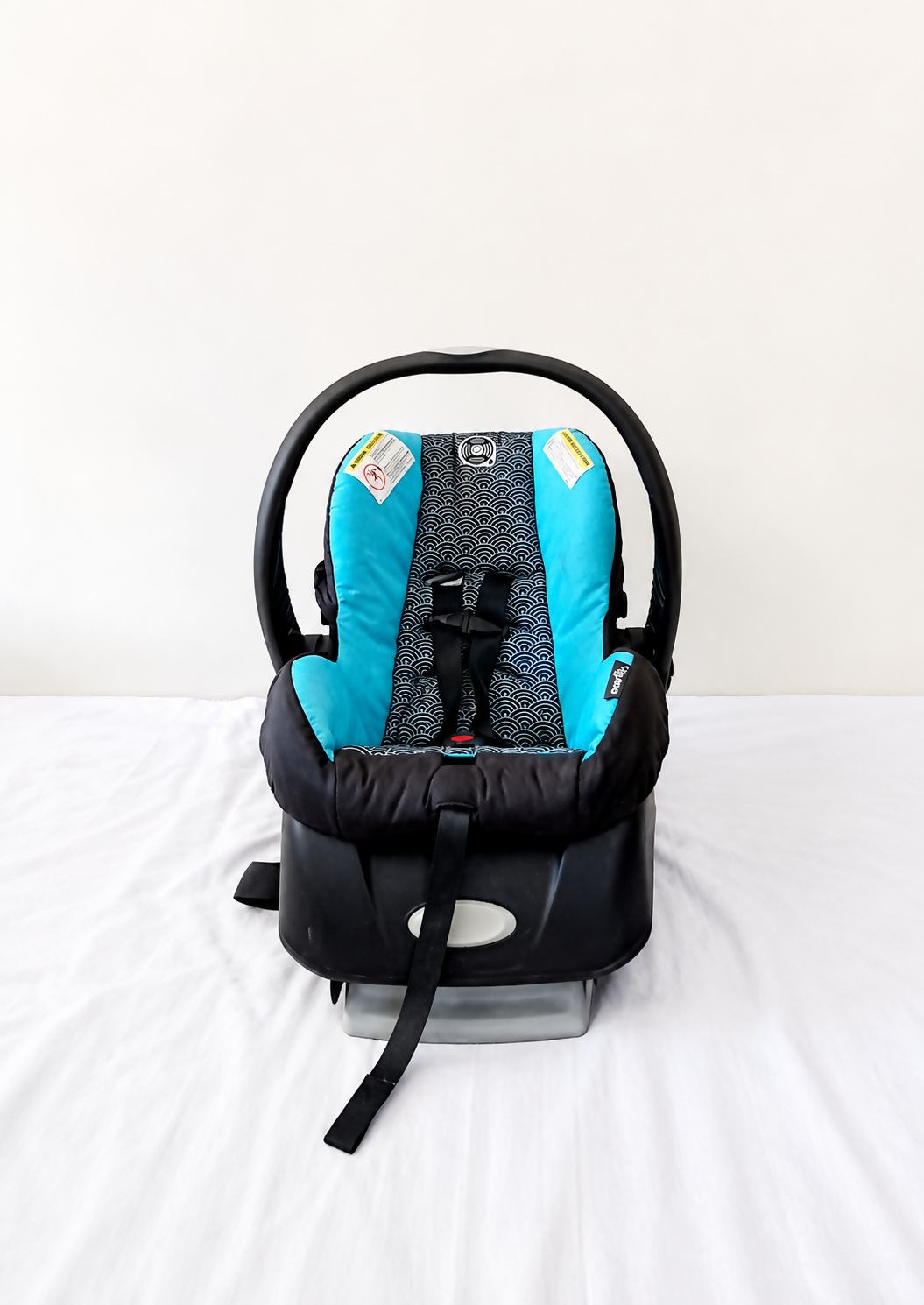 Evenflo Embrace infant car seat with base, rear-facing design, cushioned newborn support, secure safety harness, and portable baby carrier functionality for safe travel.
