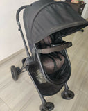 Evenflo travel system with baby stroller and infant car seat, featuring a foldable design, reclining seat, adjustable canopy, 5-point safety harness, and spacious storage basket for convenient travel.