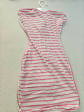 Striped dress with red and white pattern on a beige surface