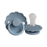 Two blue pacifiers with scalloped edges on a white background