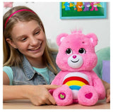 a pink teddy bear with a rainbow design