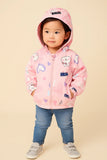 Child wearing a pink hoodie with cartoon designs