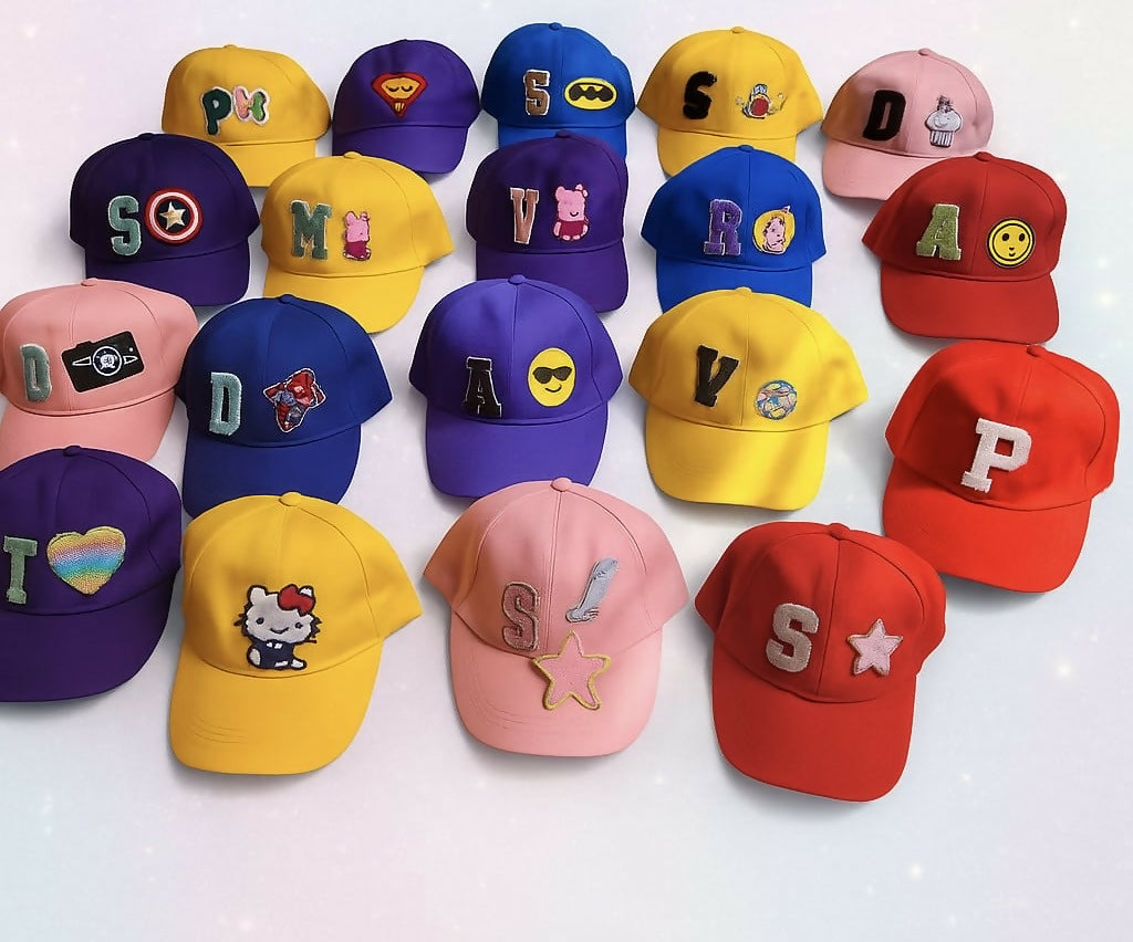 Collection of colorful children's baseball caps with various designs and letters