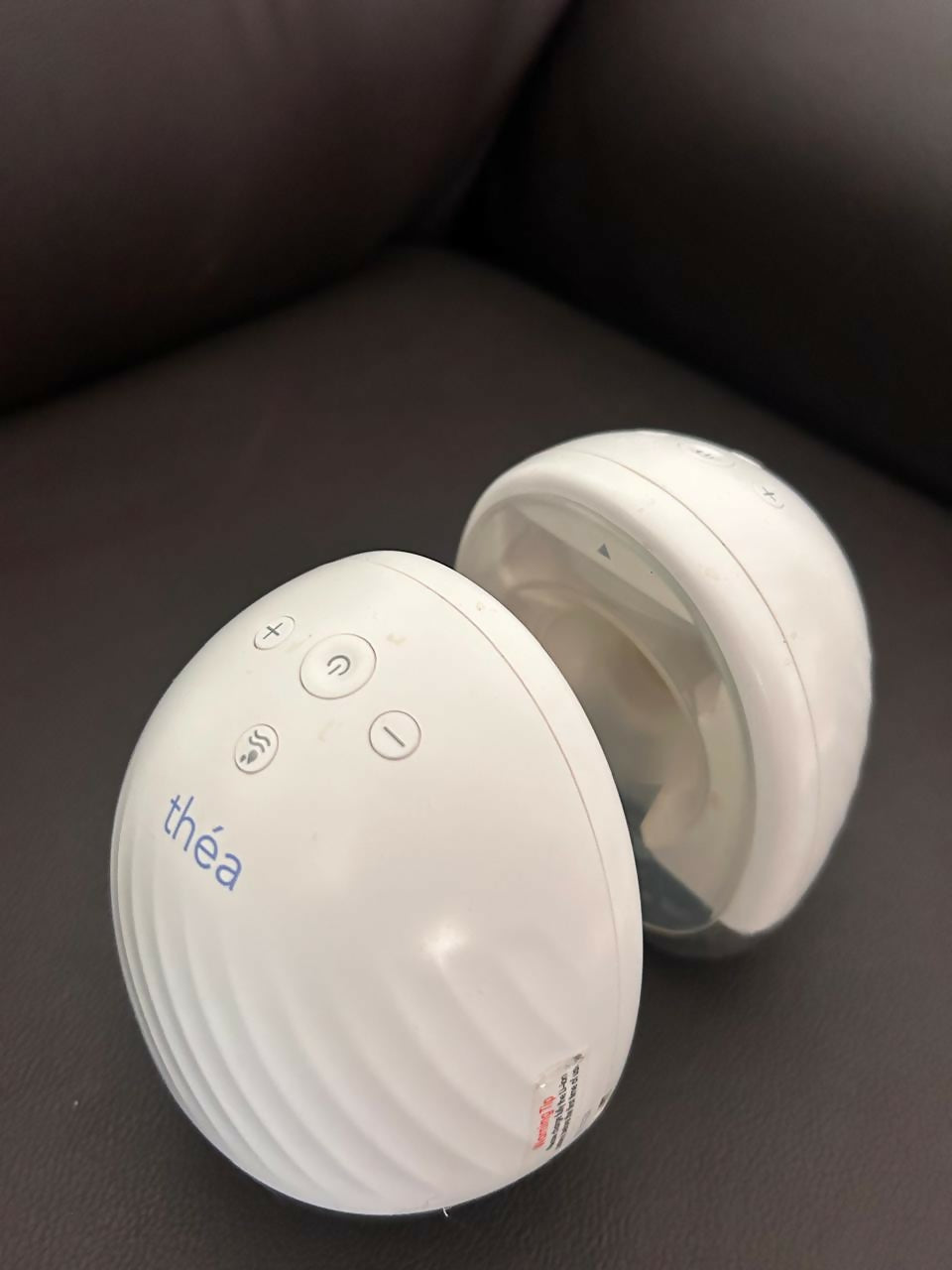 Théa wearable electric breast pump with hands-free design, compact milk collection cups, adjustable suction, and portable pumping support for breastfeeding mothers.