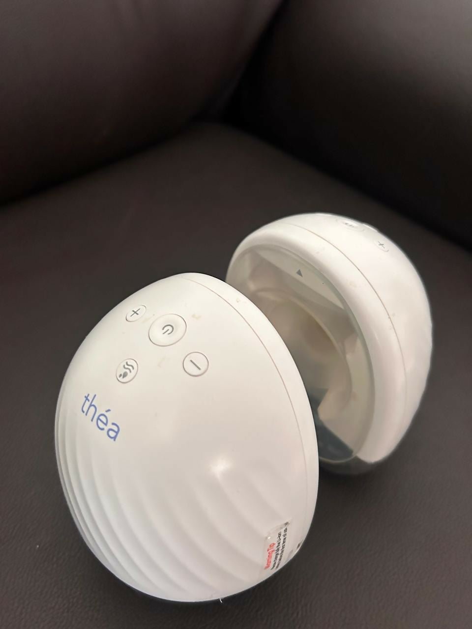 Théa wearable electric breast pump with hands-free design, compact milk collection cups, adjustable suction, and portable pumping support for breastfeeding mothers.