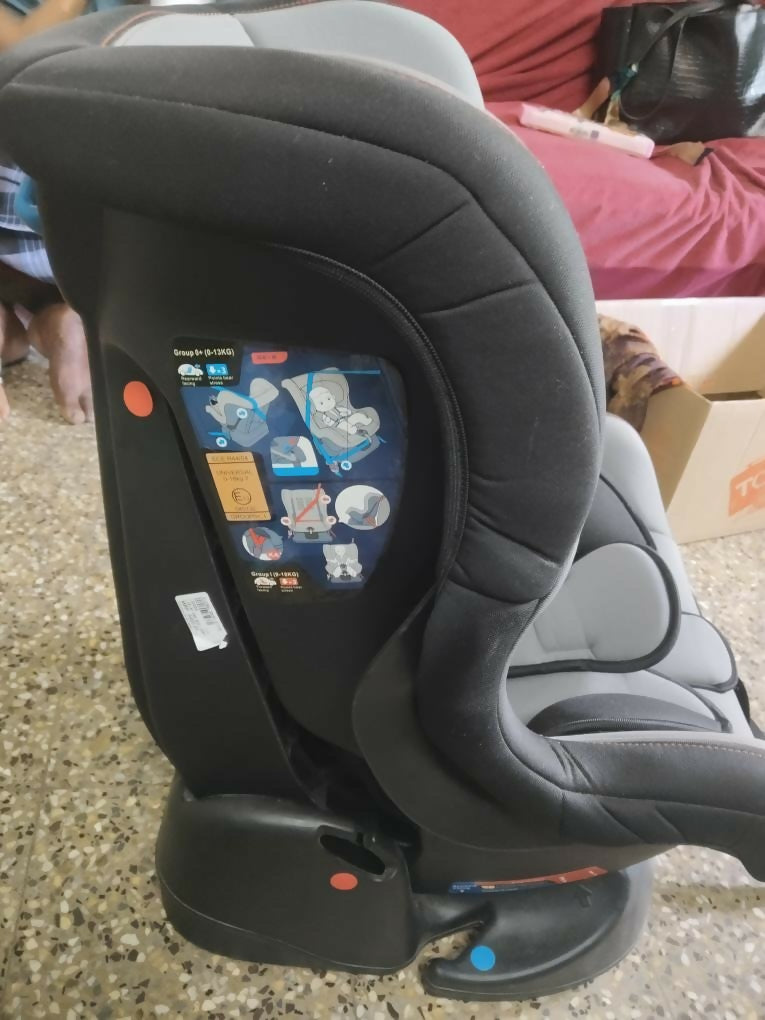 Child car seat with digital display on a concrete floor