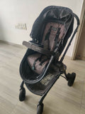 Evenflo travel system with baby stroller and infant car seat, featuring a foldable design, reclining seat, adjustable canopy, 5-point safety harness, and spacious storage basket for convenient travel.