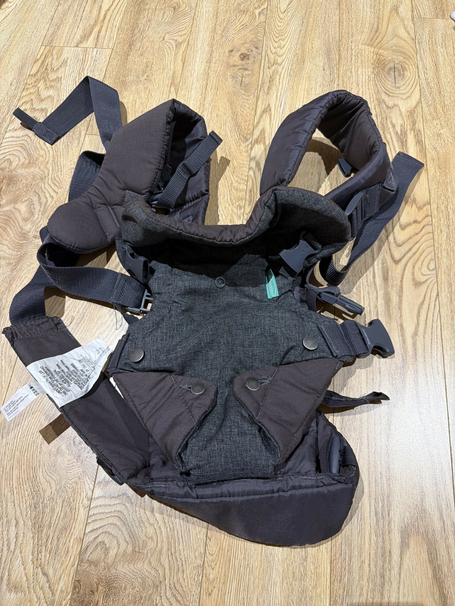 Infantino Flip 4-in-1 Convertible Carrier in Grey with an adjustable ergonomic seat, head support, padded shoulder straps, waist belt, and four carrying positions for babies weighing 3.6–14.5 kg.