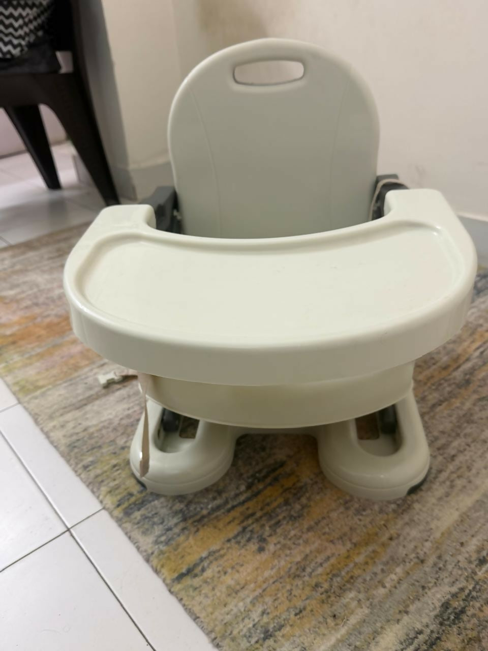 Children's high chair on a patterned rug