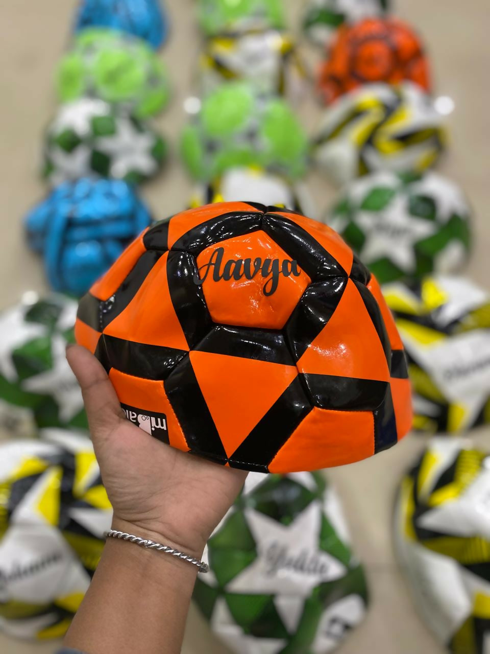 Customized size 5 football with child’s name printed, available in random colors with theme-based personalization options.