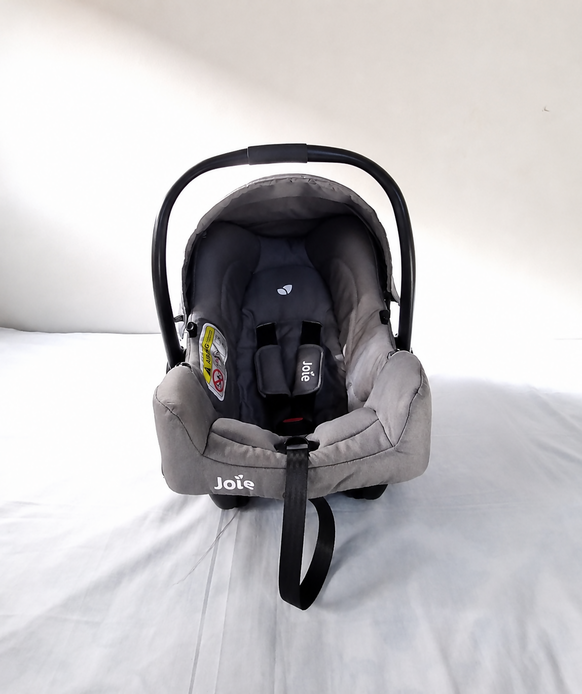 JOIE Gemm Infant Car Seat B134 in Almost New condition, rear-facing for newborns up to 13 kg, featuring a secure harness, comfortable padded seating, protective canopy, and convenient infant travel design.