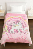 Pink unicorn-themed comforter on a bed i