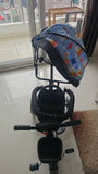 KIDSMATE Deluxe kids tricycle with adjustable canopy, parental push handle, safety harness, comfortable seat, footrest, storage basket, and durable wheels for enjoyable outdoor rides.