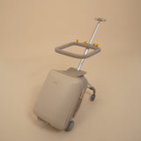 Beige suitcase with a built-in trolley on a beige background